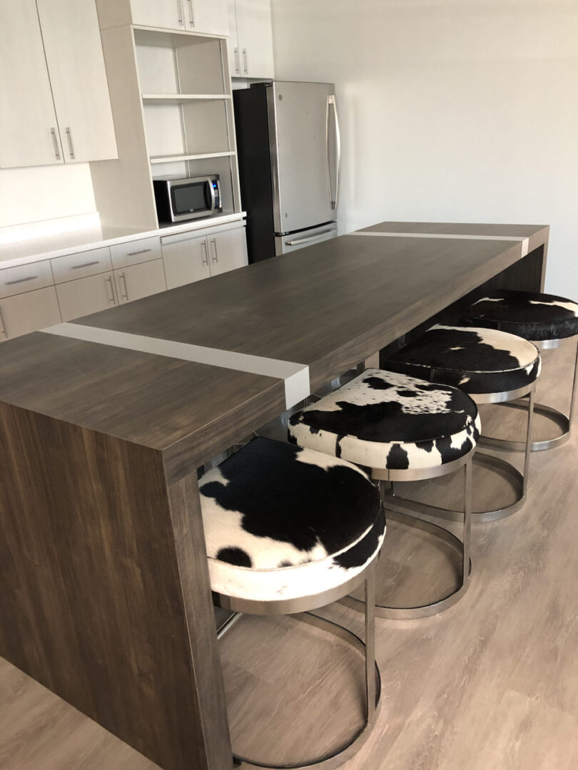 Wooden kitchen island with cowhide stools