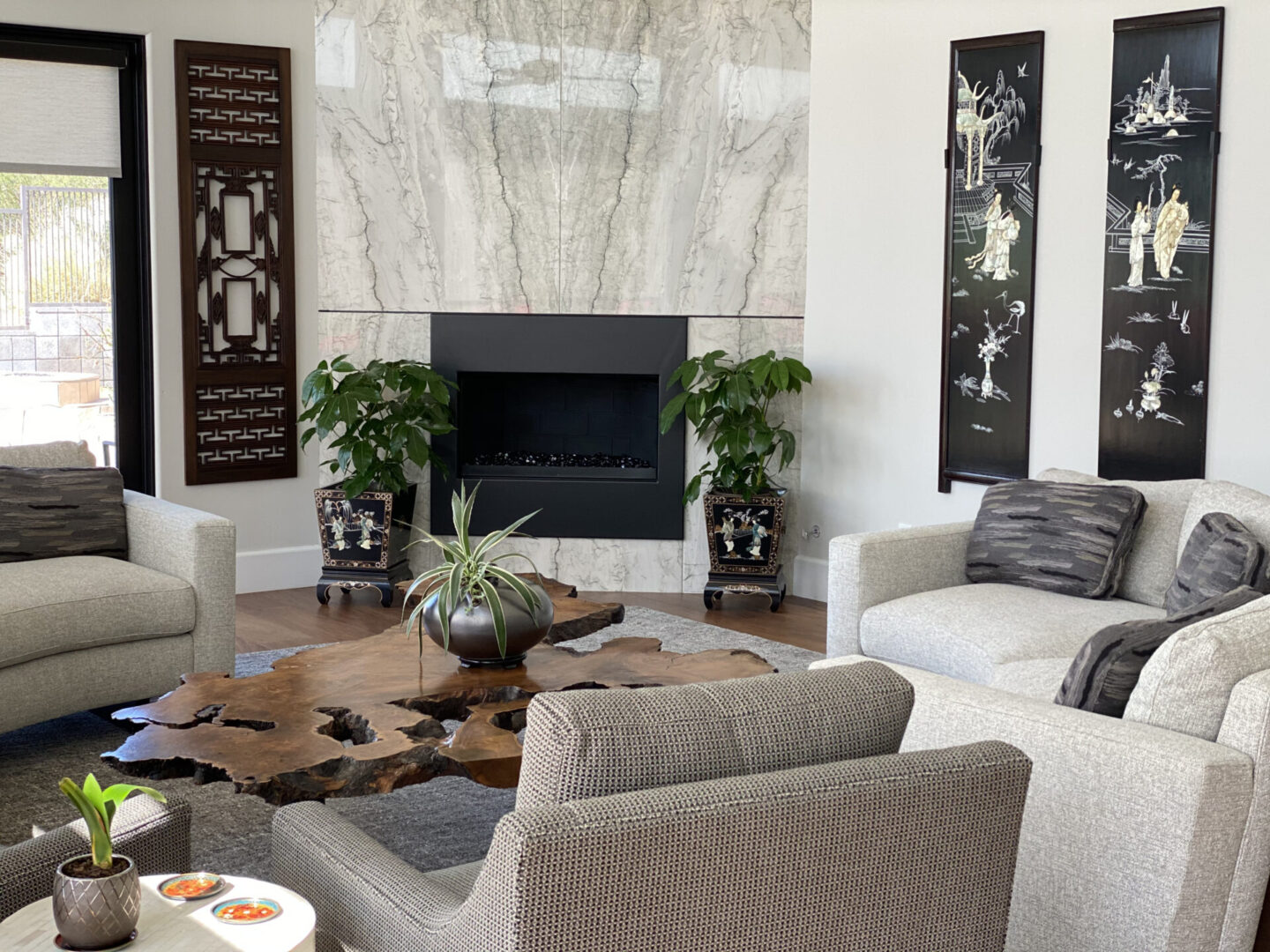 Modern living room with marble fireplace and plants