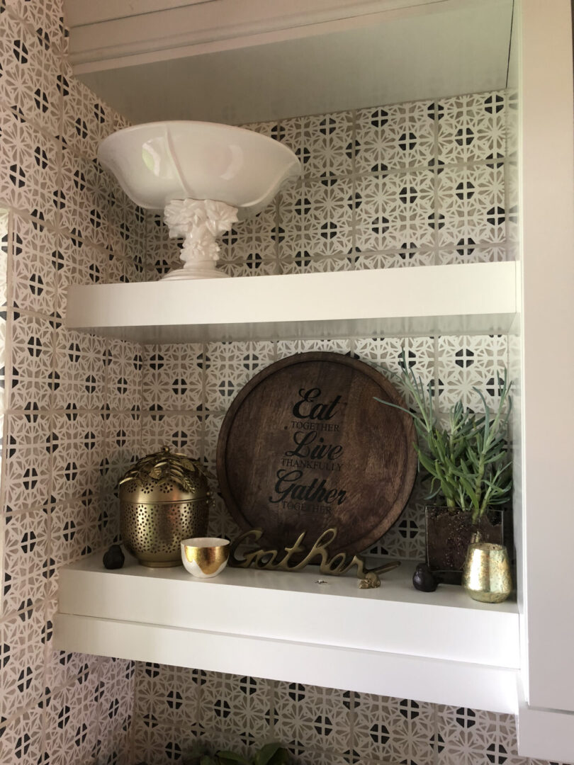 Decorative kitchen shelves with wooden sign and plant