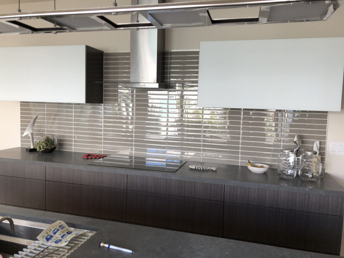 Modern kitchen with dark cabinets and backsplash